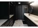 Modern primary bathroom walk-in closet featuring marble tile floors, black cabinetry, and shelving at 4317 E Ludlow Dr, Phoenix, AZ 85032