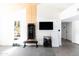 Bright workout room featuring mounted workout machine, bench, storage shelf, and gray carpet at 4317 E Ludlow Dr, Phoenix, AZ 85032