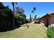 Expansive backyard with a covered patio, mature trees, and ample space for outdoor activities and relaxation at 4609 E Monte Cristo Ave, Phoenix, AZ 85032