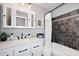 Modern bathroom with marble countertop, white cabinetry, and tiled shower/tub combo at 4609 E Monte Cristo Ave, Phoenix, AZ 85032