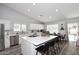Bright kitchen features an island with bar seating, stainless steel appliances, and tile backsplash at 4609 E Monte Cristo Ave, Phoenix, AZ 85032