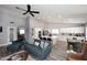 Open-concept living room with kitchen island, stainless appliances, and modern lighting fixtures at 4609 E Monte Cristo Ave, Phoenix, AZ 85032