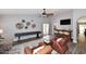 Spacious living room with a ceiling fan, hardwood floors, stylish decor, and a built-in bar at 4609 E Monte Cristo Ave, Phoenix, AZ 85032