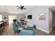 Bright living room with vaulted ceilings, ceiling fan, and sliding glass door leading to the outdoor space at 4609 E Monte Cristo Ave, Phoenix, AZ 85032