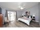 Stylish main bedroom with a ceiling fan, wood-look floors, and French doors leading to the backyard at 4609 E Monte Cristo Ave, Phoenix, AZ 85032