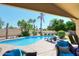Inviting backyard pool with lounge chairs, lush landscaping, and a covered patio area at 4609 E Monte Cristo Ave, Phoenix, AZ 85032