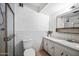 Bathroom featuring a glass door shower, white tile, and vanity sink at 4828 N 71St Ave, Phoenix, AZ 85033