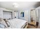 Bright bedroom features an open closet, light blue walls, and a doorway to an attached bathroom at 4828 N 71St Ave, Phoenix, AZ 85033