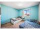 This bedroom has light blue walls, a window, and two twin beds at 4828 N 71St Ave, Phoenix, AZ 85033