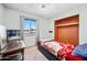 Bedroom featuring built-in shelves, a window letting in natural light, and a twin bed at 4828 N 71St Ave, Phoenix, AZ 85033