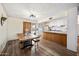 Dining area with wood flooring and a view into the bright kitchen at 4828 N 71St Ave, Phoenix, AZ 85033