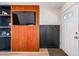 Inviting entryway featuring stylish wood paneling with built-in shelving and a coat rack at 4828 N 71St Ave, Phoenix, AZ 85033