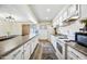 Spacious kitchen with white cabinets, stone counters, and modern appliances at 4828 N 71St Ave, Phoenix, AZ 85033