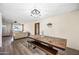 Open living room featuring wood floors, modern light fixture and dining table with bench seating at 4828 N 71St Ave, Phoenix, AZ 85033