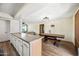 Open floor plan with kitchen bar leading to the dining and living area at 4828 N 71St Ave, Phoenix, AZ 85033