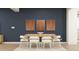Elegant dining room with modern table and chairs, with decorative wall art at 4987 S 233Rd Dr, Buckeye, AZ 85326