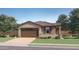 Charming single-story home with a tile roof, neat landscaping, and a two-car garage at 4987 S 233Rd Dr, Buckeye, AZ 85326