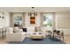 Bright living room with stylish decor, comfortable seating, and large windows at 4987 S 233Rd Dr, Buckeye, AZ 85326