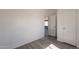 Bedroom showing a view into another room with grey floors at 54073 W Stallion Rd, Maricopa, AZ 85139