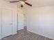 A bright bedroom with a ceiling fan and ample closet space at 54073 W Stallion Rd, Maricopa, AZ 85139