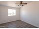 Bedroom with large window providing a desert view and featuring new flooring at 54073 W Stallion Rd, Maricopa, AZ 85139