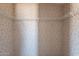 Walk in closet featuring wire shelving and wallpaper at 54073 W Stallion Rd, Maricopa, AZ 85139