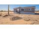 Charming single-story home featuring a desert landscape, large windows, and a well-maintained exterior at 54073 W Stallion Rd, Maricopa, AZ 85139