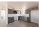 Corner view of a new kitchen with gray cabinets and stainless appliances at 54073 W Stallion Rd, Maricopa, AZ 85139
