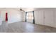 Living room features hardwood floors, a ceiling fan, large windows, and a bright airy atmosphere at 54073 W Stallion Rd, Maricopa, AZ 85139