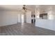 Open concept living room featuring hardwood floors, a view of the kitchen, and neutral wall colors at 54073 W Stallion Rd, Maricopa, AZ 85139
