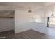 Open-concept living room with new floors and views of a desert landscape at 54073 W Stallion Rd, Maricopa, AZ 85139