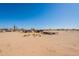 A property with desert landscape, featuring sparse vegetation under a clear sky at 54073 W Stallion Rd, Maricopa, AZ 85139