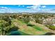 Panoramic aerial view of a vibrant community surrounding a lush golf course, with mountain views in the distance at 633 Leisure World --, Mesa, AZ 85206