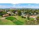 Scenic aerial view of a lush green golf course surrounded by residential homes, with a backdrop of mountains at 633 Leisure World --, Mesa, AZ 85206