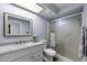Modern bathroom featuring a white vanity with sink and quartz countertop, and a glass shower at 633 Leisure World --, Mesa, AZ 85206