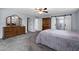 Bedroom with grey carpet and a wooden dresser, and a glimpse of a bathroom with white sliding doors at 633 Leisure World --, Mesa, AZ 85206