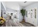 Welcoming entryway with hardwood floors that transitions into a modern, open-concept kitchen with white cabinets at 633 Leisure World --, Mesa, AZ 85206
