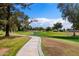 Scenic golf course view with mature trees, lush green grass, and a winding cart path at 633 Leisure World --, Mesa, AZ 85206