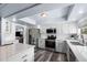 Beautiful kitchen boasts stainless steel appliances, island with seating, and sleek white cabinets at 633 Leisure World --, Mesa, AZ 85206