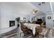 Open living room and dining area with fireplace and gray wood-look flooring at 633 Leisure World --, Mesa, AZ 85206