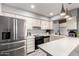 Bright kitchen with stainless steel appliances, white cabinets, and a large countertop at 6348 N 7Th Ave # 6, Phoenix, AZ 85013