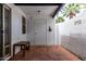 Charming outdoor patio with classic terracotta tile and bright white walls and a wooden bench at 6348 N 7Th Ave # 6, Phoenix, AZ 85013