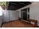 Private patio area featuring red tile flooring, white stucco walls, and sliding glass door at 6348 N 7Th Ave # 6, Phoenix, AZ 85013