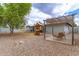 Large backyard with play structure for and a shaded seating area, perfect for Gathering enjoyment and leisure at 6869 E Flossmoor Ave, Mesa, AZ 85208