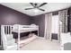 Cozy bedroom with bunkbeds, ceiling fan, carpet, and a window with natural light at 6869 E Flossmoor Ave, Mesa, AZ 85208