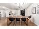 Open-concept dining area connects seamlessly with the living room and features a wooden table at 6869 E Flossmoor Ave, Mesa, AZ 85208
