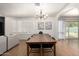 Bright dining room features wood floors, shuttered windows, and a modern light fixture at 6869 E Flossmoor Ave, Mesa, AZ 85208