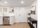 Bright entryway features white subway tile, stainless steel dishwasher, wood floors, and stylish decor at 6869 E Flossmoor Ave, Mesa, AZ 85208