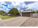 Charming single-story home with mature trees, providing great curb appeal and a long driveway at 6869 E Flossmoor Ave, Mesa, AZ 85208