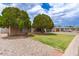 Well-maintained single-story home with mature trees, providing great curb appeal and a driveway at 6869 E Flossmoor Ave, Mesa, AZ 85208